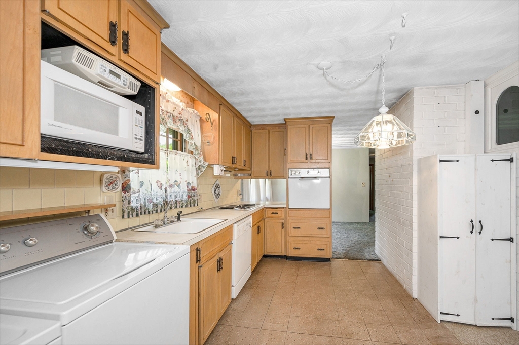 13 Judith Road Chelmsford, MA 01824 - Photo 6 of 36 a kitchen that has a lot of cabinets in it