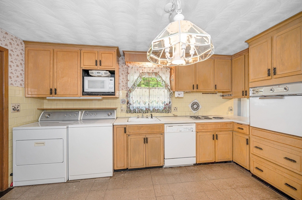 13 Judith Road Chelmsford, MA 01824 - Photo 7 of 36 a kitchen with white cabinets and white appliances