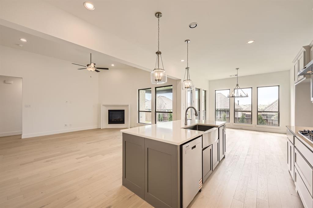 167 Sandie Drive Rhome, TX 76078 - Photo 11 of 29 Kitchen with white dishwasher, a sink, light wood-type flooring, and recessed lighting