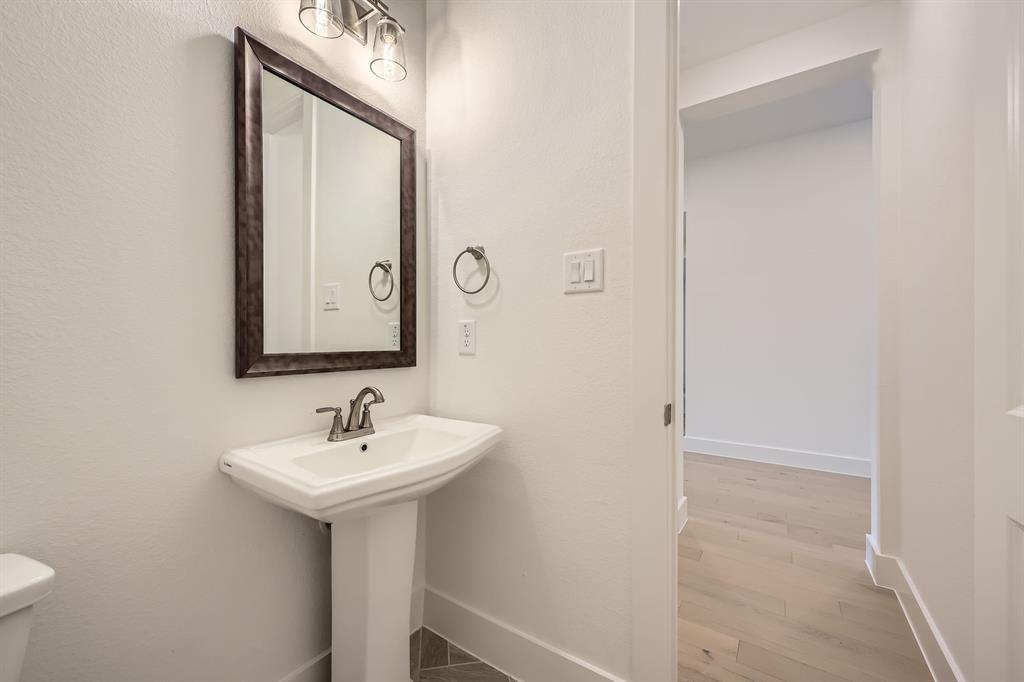167 Sandie Drive Rhome, TX 76078 - Photo 13 of 29 Half bath with baseboards, wood finished floors, toilet, and a sink