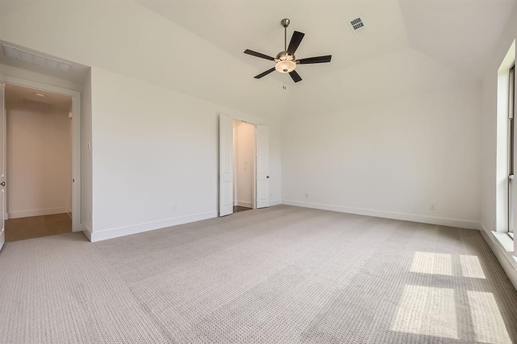 167 Sandie Drive Rhome, TX 76078 - Photo 15 of 29 Spare room featuring light carpet, ceiling fan, lofted ceiling, and baseboards