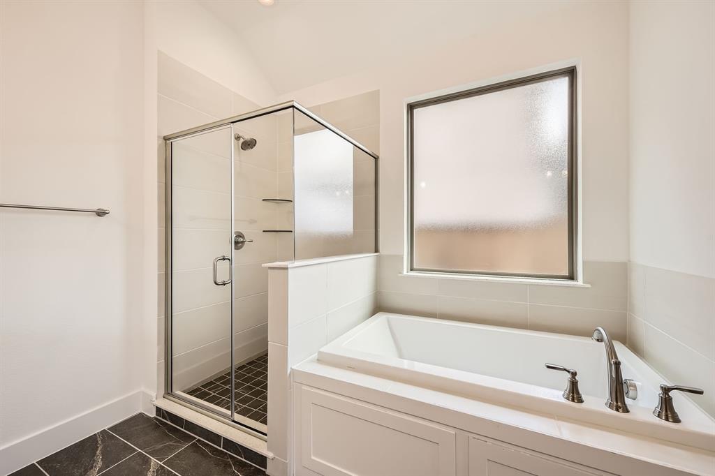 167 Sandie Drive Rhome, TX 76078 - Photo 17 of 29 Bathroom featuring a stall shower, marble finish flooring, a bath, and baseboards
