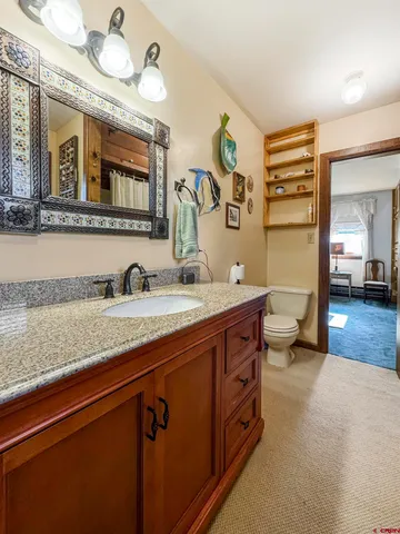 a spacious bathroom with a granite countertop double vanity sink and a mirror
