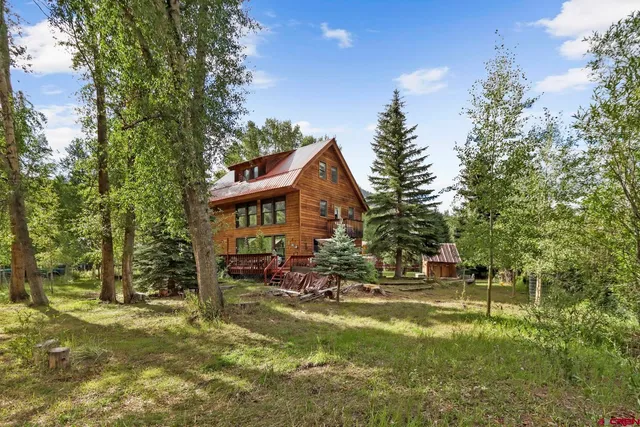a view of a house with backyard porch and sitting area
