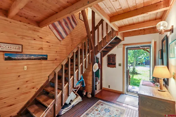 a view of an entryway with wooden floor and door
