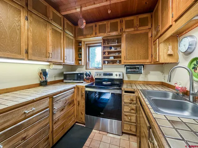 a kitchen with stainless steel appliances granite countertop a sink and cabinets