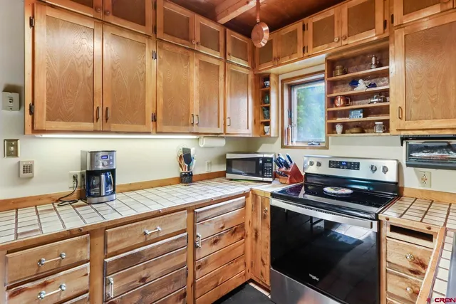 a kitchen with granite countertop cabinets stainless steel appliances and a counter space