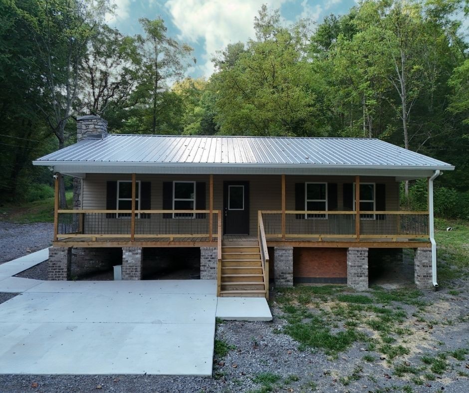 778 Jones Hollow Road Woodbury, TN 37190 - Photo 1 of 19 a front view of a house with a garden