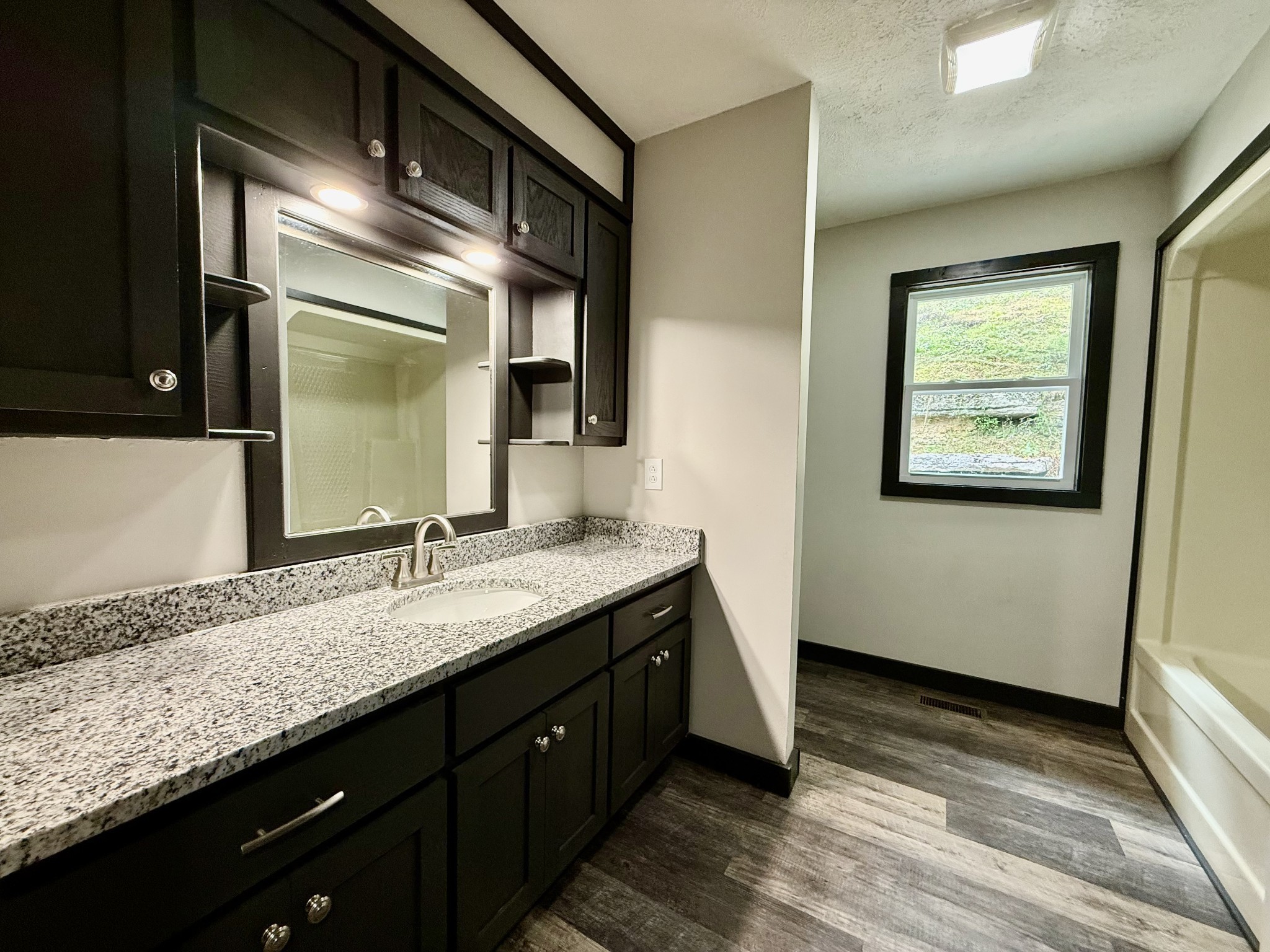 778 Jones Hollow Road Woodbury, TN 37190 - Photo 12 of 19 a bathroom with a granite countertop double vanity sink and a mirror