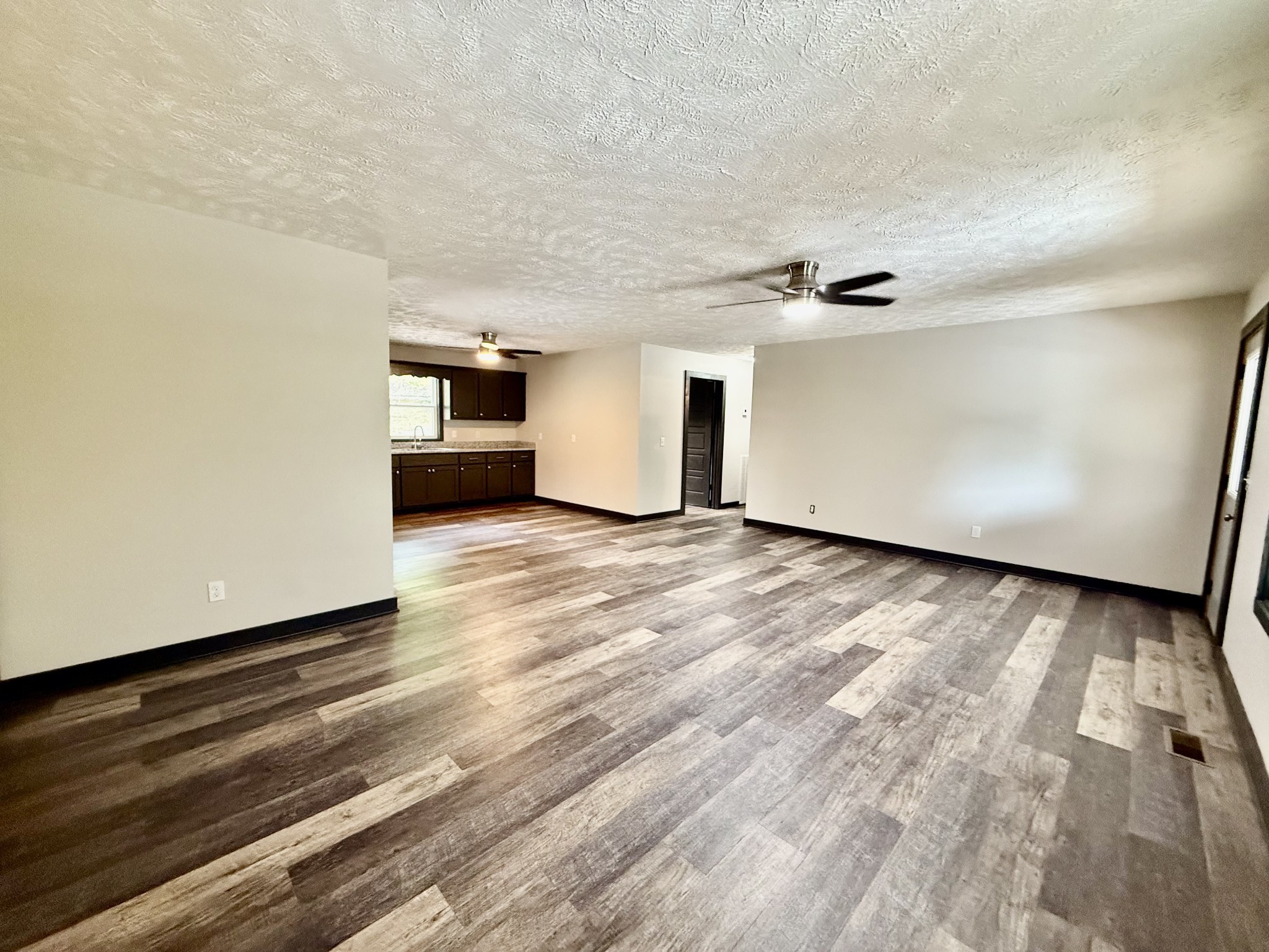 778 Jones Hollow Road Woodbury, TN 37190 - Photo 5 of 19 a view of a livingroom with wooden floor and a ceiling fan