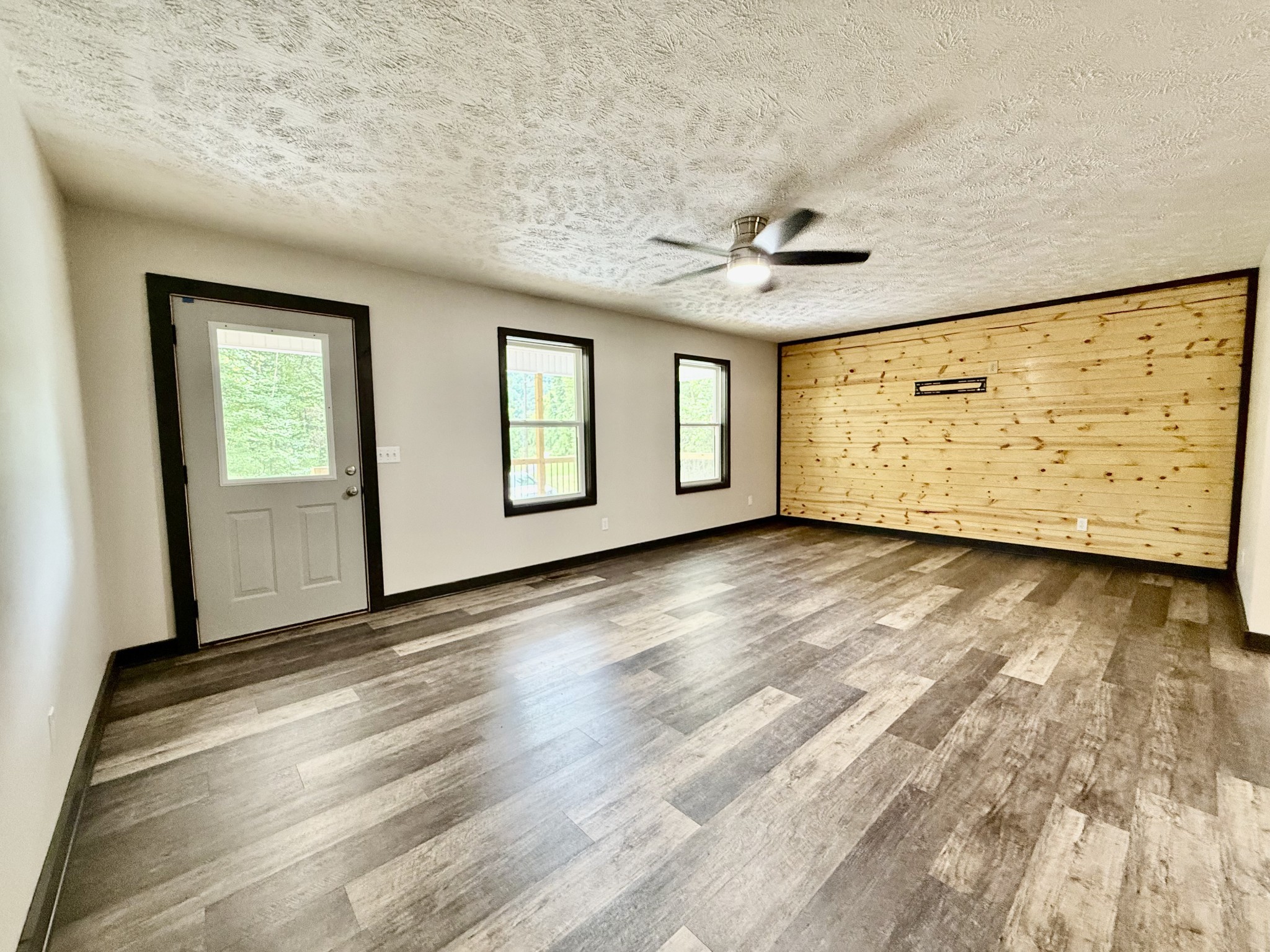 778 Jones Hollow Road Woodbury, TN 37190 - Photo 6 of 19 a view of an empty room with window and wooden floor