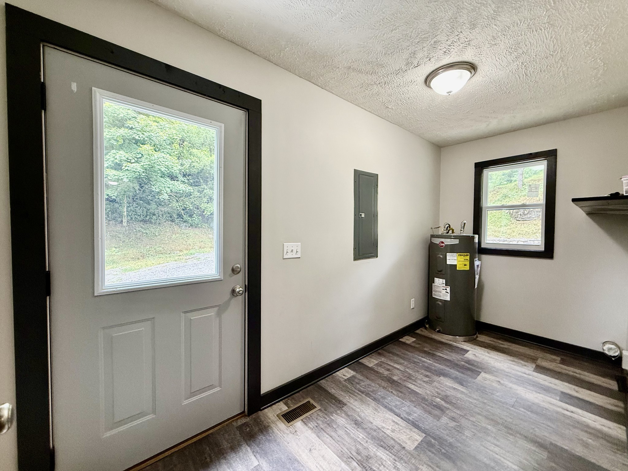 778 Jones Hollow Road Woodbury, TN 37190 - Photo 9 of 19 a view of an empty room with wooden floor and a window