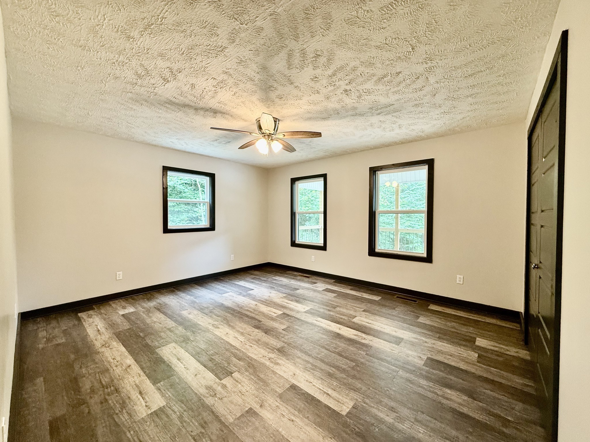 778 Jones Hollow Road Woodbury, TN 37190 - Photo 10 of 19 a view of an empty room with wooden floor and a window