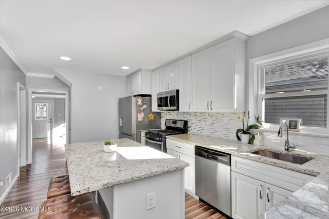 a kitchen with stainless steel appliances granite countertop a sink and cabinets