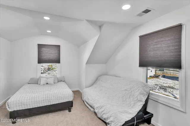 a bedroom with a bed and glass wall