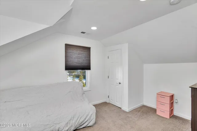 a bed room with a bed and a television