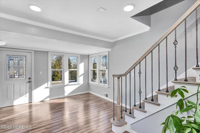 a view of an entryway with wooden floor and windows