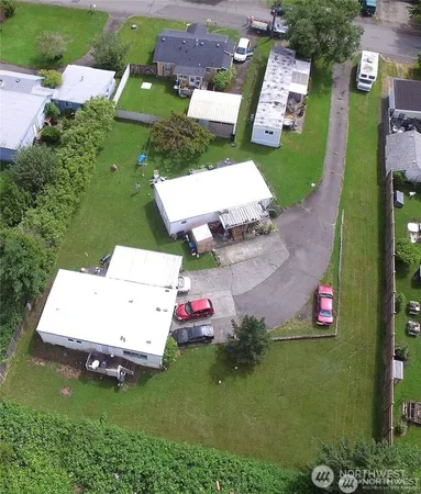 an aerial view of a house with a garden and swimming pool