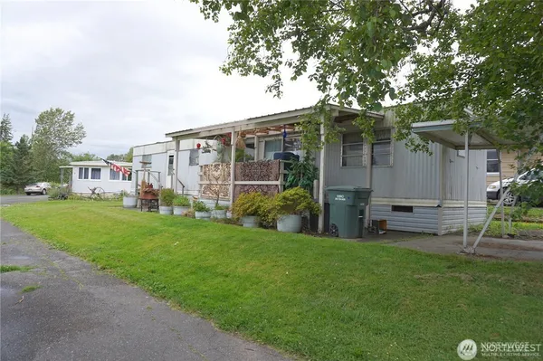 a view of a chair and table in backyard of the house