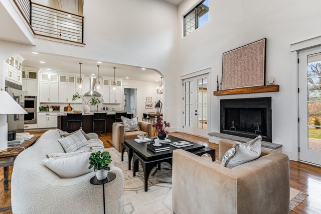 a living room with furniture kitchen view and a fireplace