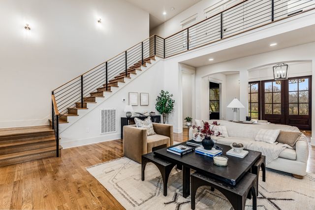 a living room with furniture a table and a potted plant