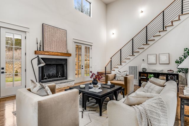 a living room with furniture a fireplace and a table