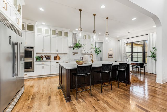 a large kitchen with lots of counter space and dining table