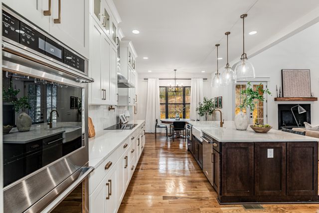 a kitchen with kitchen island granite countertop lots of counter top space and stainless steel appliances
