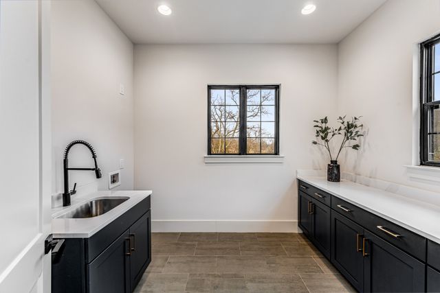 a kitchen with a sink cabinets and window