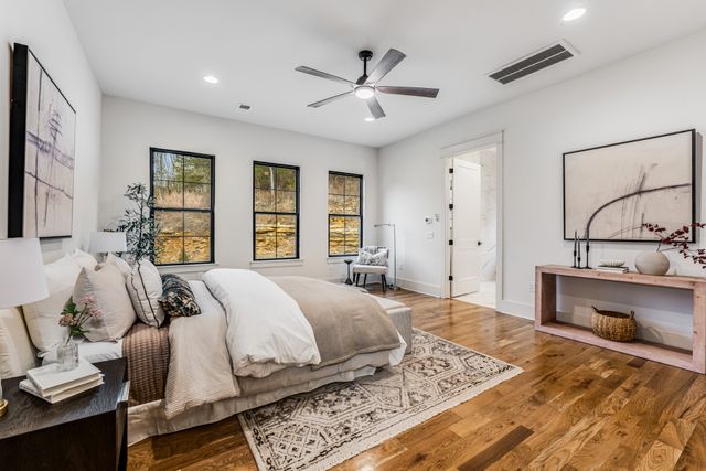 a bedroom with a large bed and a chandelier