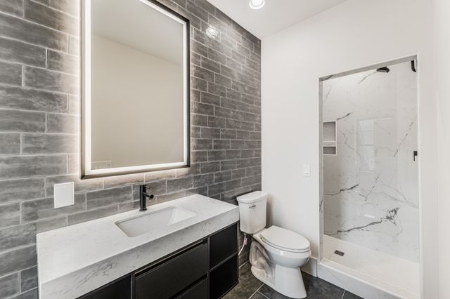 a bathroom with a sink toilet and shower