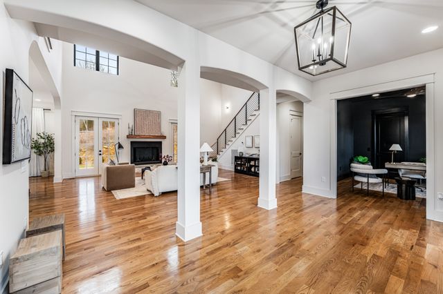 a living room with furniture and a chandelier