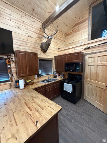 785 Hardscrabble Road Morgan, UT 84050 - Photo 16 of 16 Vaulted planked wood ceiling with exposed beam, wood-finish wall paneling, and wood-finish flooring