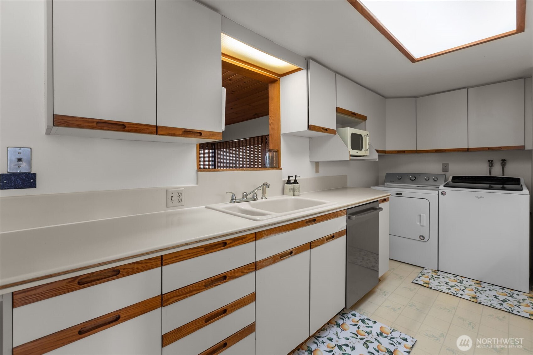 16022 126th Avenue Southeast Renton, WA 98058 - Photo 5 of 35 a kitchen with a sink cabinets and window