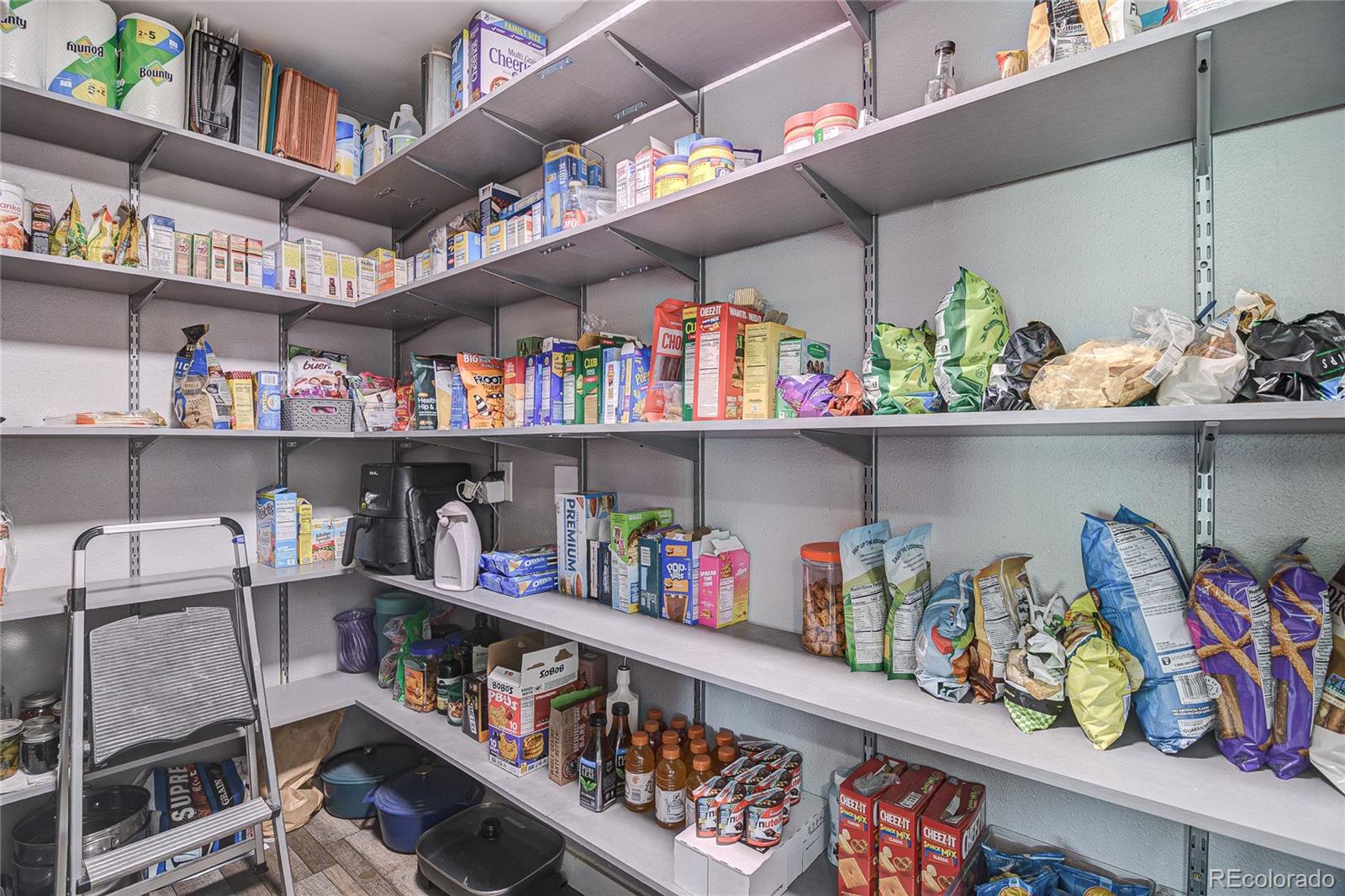 4531 East Best Road Larkspur, CO 80118 - Photo 12 of 49 a cabinet with lots of different kinds of food