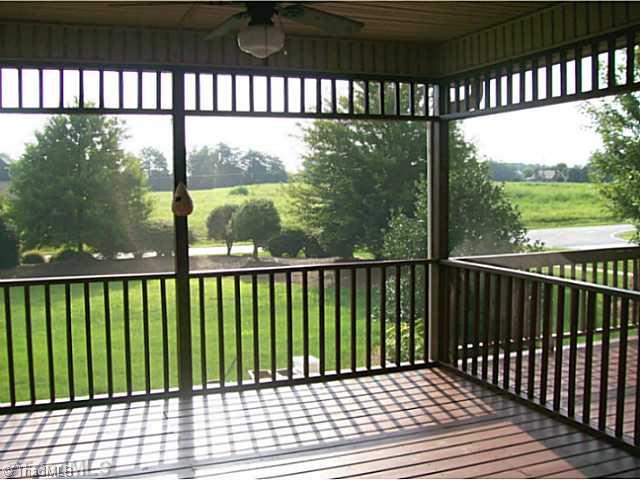 5700 Mabe Drive Oak Ridge, NC 27310 - Photo 15 of 16 Screened Porch. 14x14 screened porch overlooking manicured yard. Great space to enjoy the outdoors without rain or bugs.