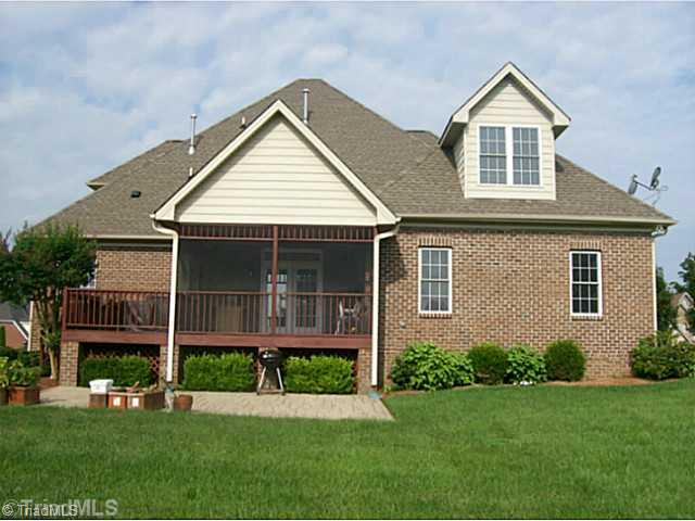 5700 Mabe Drive Oak Ridge, NC 27310 - Photo 3 of 16 Exterior Back. Beautifully manicured landscaping and yard with screened porch, deck and patio for outdoor fun.