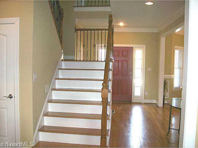 5700 Mabe Drive Oak Ridge, NC 27310 - Photo 4 of 16 Entry. Stunning foyer says Welcome with elegant banister and balcony overlooking den and entry.