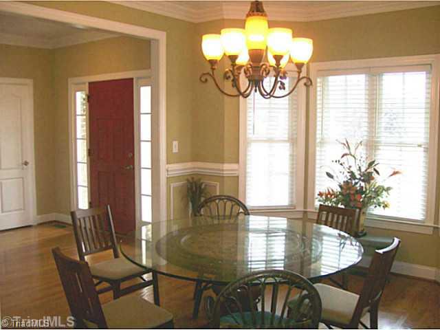 5700 Mabe Drive Oak Ridge, NC 27310 - Photo 5 of 16 Dining Room. Sizable dining room set in a bay with nice moldings and open to entry and kitchen.