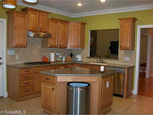 5700 Mabe Drive Oak Ridge, NC 27310 - Photo 7 of 16 Kitchen. Great working kitchen with island. Includes Bosch DW, gas cooktop, built-in microwave and 30" oven. Also, leaving refrigerator.