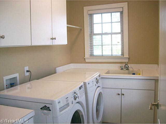 5700 Mabe Drive Oak Ridge, NC 27310 - Photo 9 of 16 Laundry Room. Main level laundry room with abundance of cabinets and laundry sink and space to hang your clothes. Washer and dryer remain.