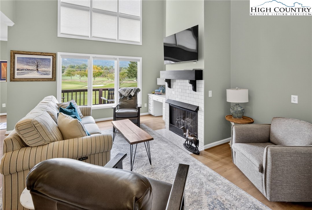 233 Lakeview Place, Unit D2 Jefferson, NC 28640 - Photo 1 of 49 a living room with furniture a flat screen tv and a fireplace