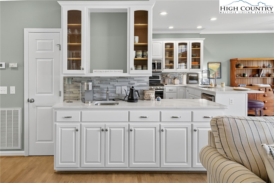 233 Lakeview Place, Unit D2 Jefferson, NC 28640 - Photo 11 of 49 a kitchen with granite countertop a sink and white cabinets