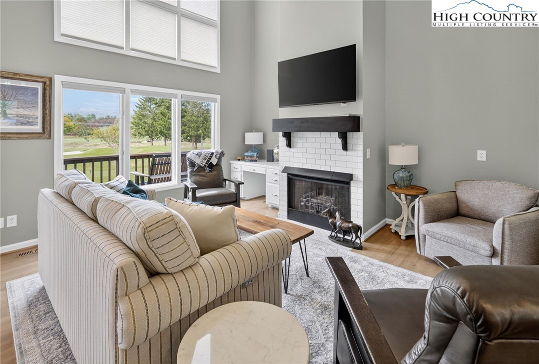 233 Lakeview Place, Unit D2 Jefferson, NC 28640 - Photo 12 of 49 a living room with furniture a flat screen tv and a fireplace