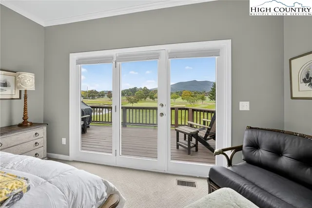 a bedroom with a balcony a bed and a couch