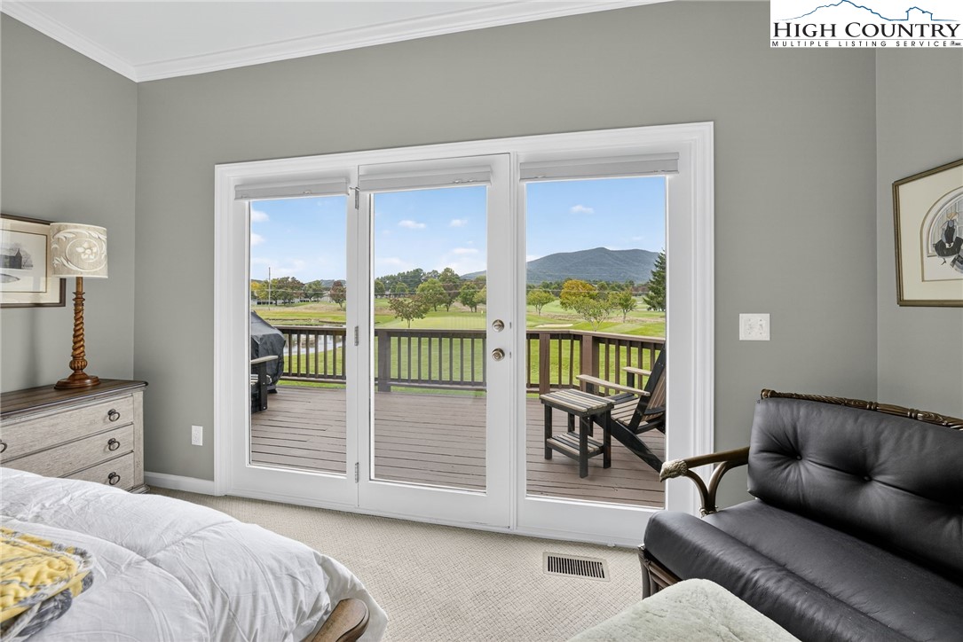 233 Lakeview Place, Unit D2 Jefferson, NC 28640 - Photo 20 of 49 a bedroom with a balcony a bed and a couch