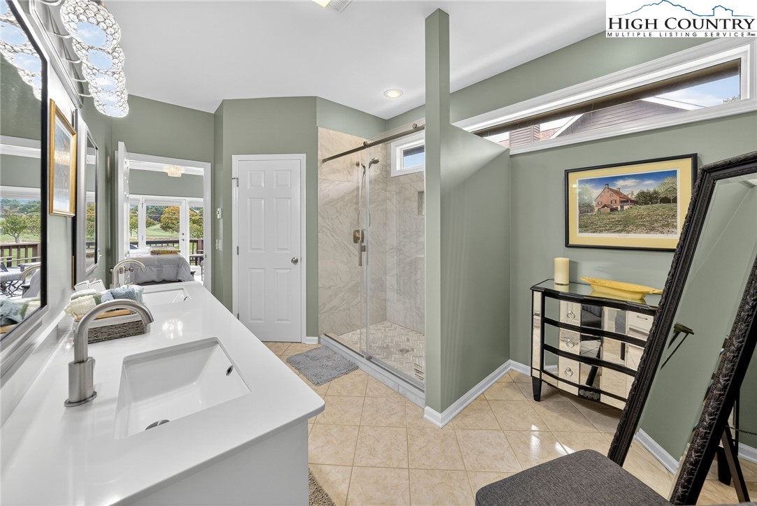 233 Lakeview Place, Unit D2 Jefferson, NC 28640 - Photo 21 of 49 a bathroom with a sink a mirror and a shower