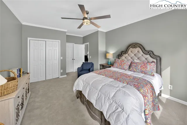 a bedroom with a bed and a ceiling fan