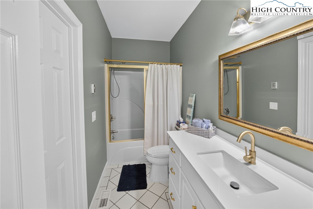 233 Lakeview Place, Unit D2 Jefferson, NC 28640 - Photo 28 of 49 a bathroom with a sink toilet and shower