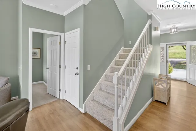 a view of entryway and hall with wooden floor